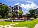 Modern apartment building with lush landscaping and water features