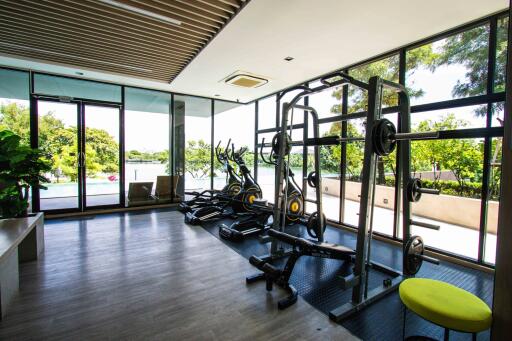 Home gym with exercise equipment and large windows