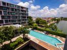 Modern apartment building with swimming pool and city views