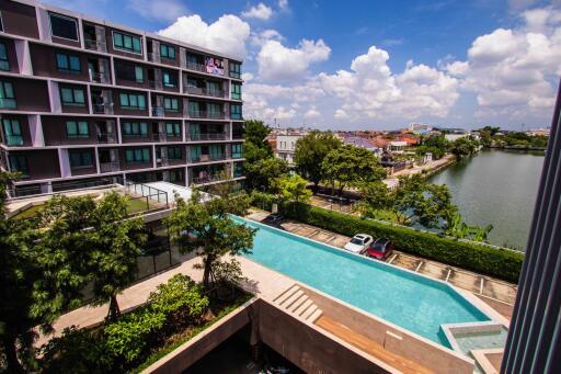 Modern apartment building with swimming pool and city views