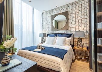 Well-decorated bedroom with patterned wallpaper, a large window, and modern furnishings