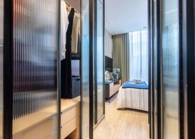 Modern bedroom with glass closet doors and natural light