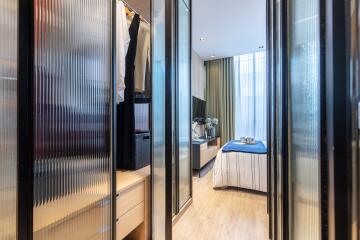 Modern bedroom with glass closet doors and natural light