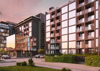 Modern apartment building with glass façade at sunset