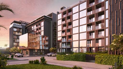 Modern apartment building with glass façade at sunset