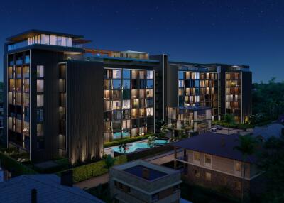 Modern residential building at night with illuminated windows and swimming pool