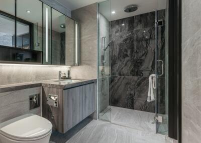 Modern bathroom with glass shower and marble tiles