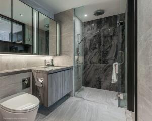 Modern bathroom with glass shower and marble tiles