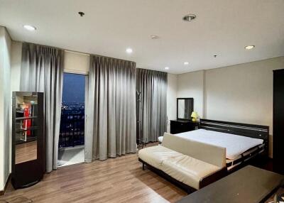 Spacious modern bedroom with city view