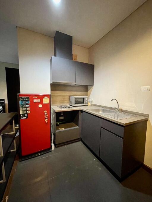 Modern kitchen with red refrigerator and appliances