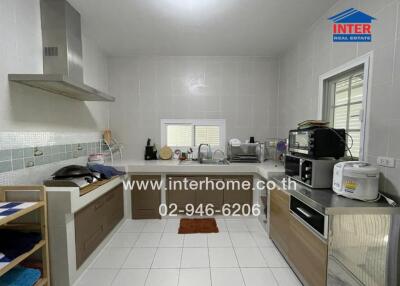 Modern kitchen with appliances and white tiles