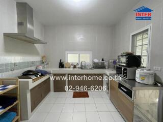 Modern kitchen with appliances and white tiles