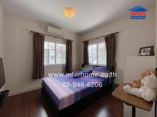 Bedroom with bed, window and air conditioner