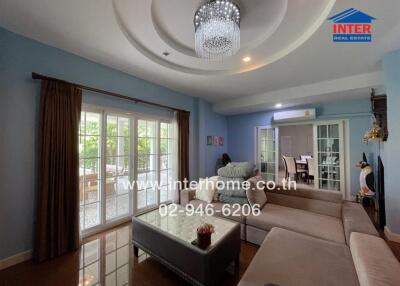 Cozy living room with chandelier and large windows