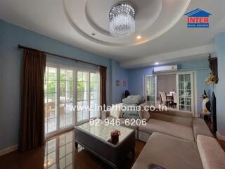 Cozy living room with chandelier and large windows