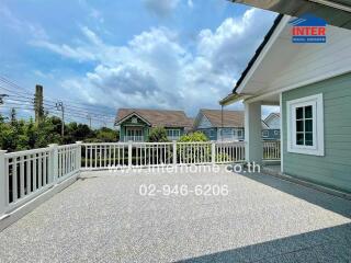 Spacious terrace with a view of neighboring houses and a blue sky