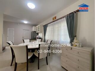 Dining room with table, chairs, and window view