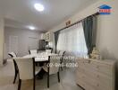 Dining room with table, chairs, and window view