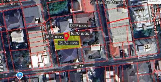 Aerial view of property plots and neighboring buildings with measurement markings.