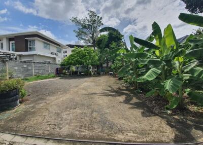 Spacious backyard with garden and trees