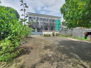 Spacious yard with a building in the background