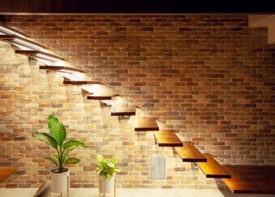 modern floating staircase with brick wall