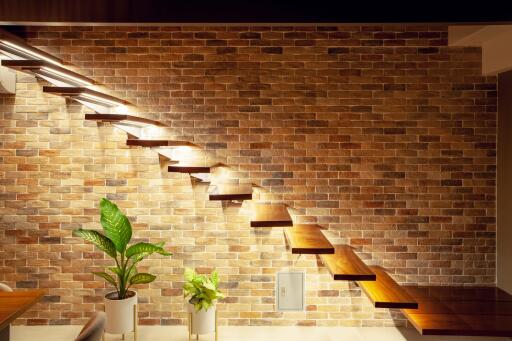 modern floating staircase with brick wall