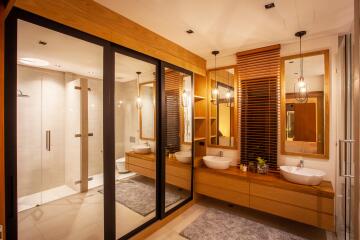 Modern bathroom with dual sinks and glass shower