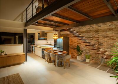 Modern kitchen and dining area with staircase and houseplants