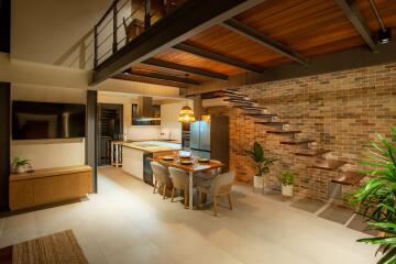 Modern kitchen and dining area with staircase and houseplants