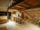 Modern kitchen and dining area with staircase and houseplants