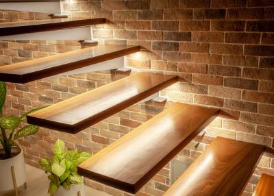 Modern wooden staircase with brick wall and plants