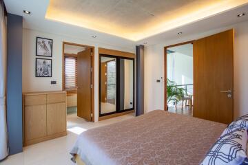 Modern bedroom with ensuite bathroom and wooden accents