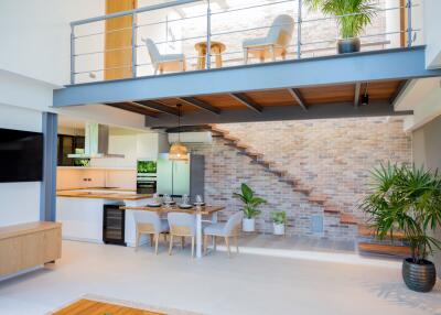 Modern living and dining area with open kitchen and mezzanine