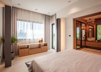 Spacious modern bedroom with large window and en-suite bathroom