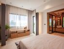 Spacious modern bedroom with large window and en-suite bathroom