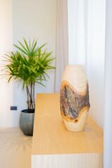 Close-up of a decorative wooden vase and a potted plant