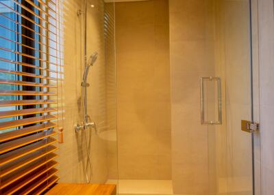 Modern bathroom with walk-in shower and wooden blinds