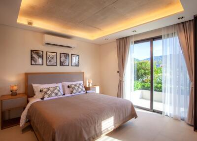 Modern bedroom with large bed, stylish lighting, and balcony view.