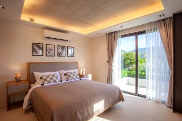 Modern bedroom with large bed, stylish lighting, and balcony view.