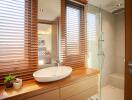 Modern bathroom with wooden blinds and walk-in shower