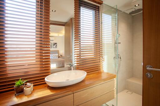 Modern bathroom with wooden blinds and walk-in shower