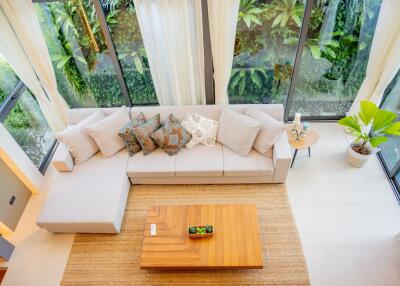 living room with large windows and a sectional sofa