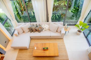 living room with large windows and a sectional sofa