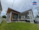 Modern single-story house with a carport and a well-maintained lawn