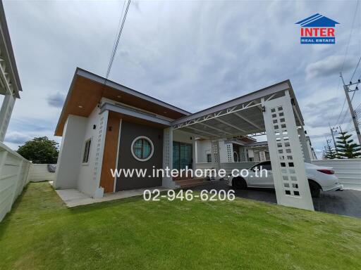 Modern single-story house with a carport and a well-maintained lawn