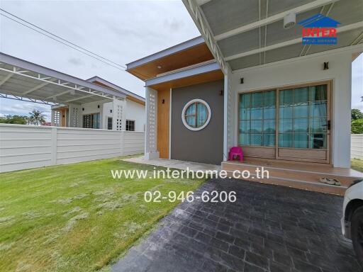 Front view of a modern house with a well-maintained lawn