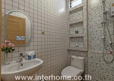 Modern white bathroom with shower and wooden flooring