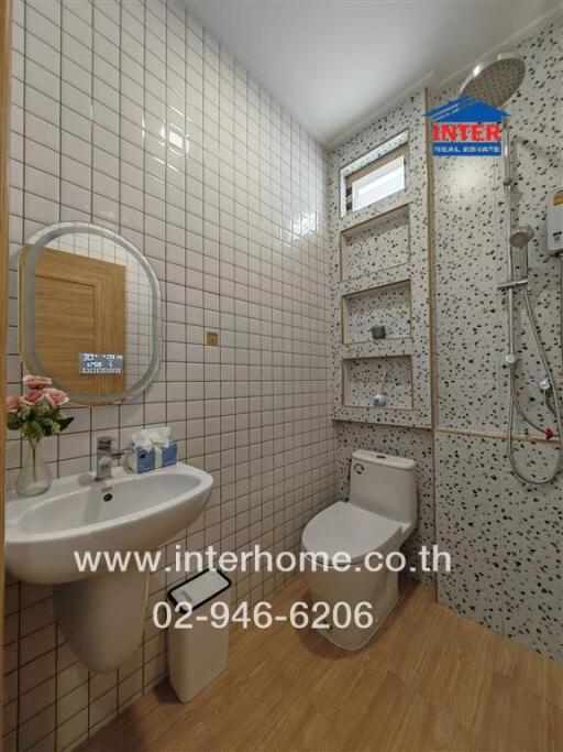 Modern white bathroom with shower and wooden flooring