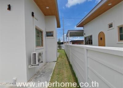 Side walkway view with adjacent houses